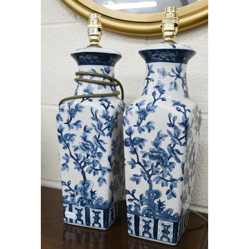 497A - A pair of India Jane blue and white ceramic lamps with chinoiserie decoration, 44 cm high