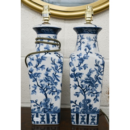 497A - A pair of India Jane blue and white ceramic lamps with chinoiserie decoration, 44 cm high