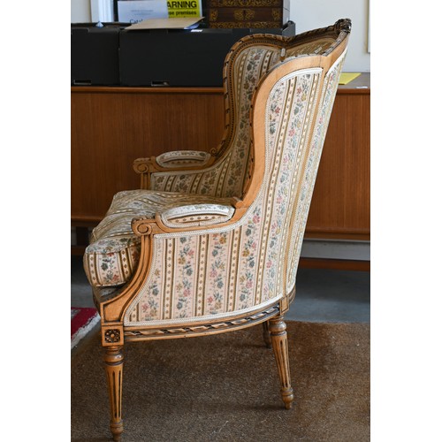 106 - A French wingback armchair, 20th century, floral brocade-style striped fabric