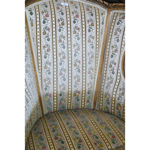 106 - A French wingback armchair, 20th century, floral brocade-style striped fabric