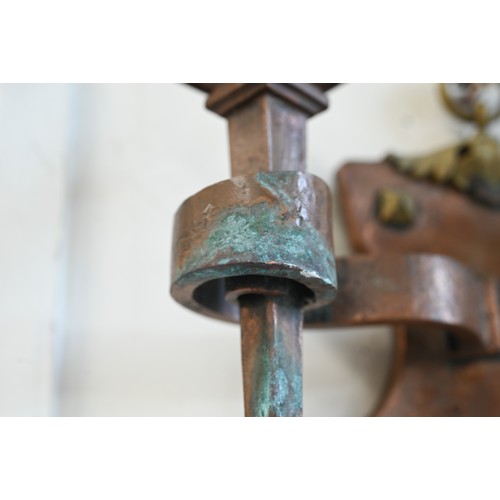 174 - A pair of Arts and Crafts copper and brass Gothic style twin branch sconces, 25 cm high