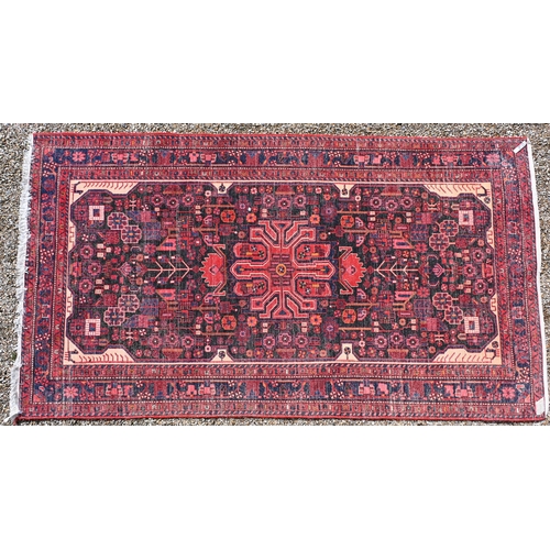 34 - An old Persian Hamadan red ground rug, stylised floral design, 300 cm x 163 cm