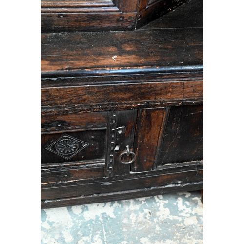 48 - A 17th century oak court cupboard, the recessed canted sided upper cupboard with arcaded moulded pan... 