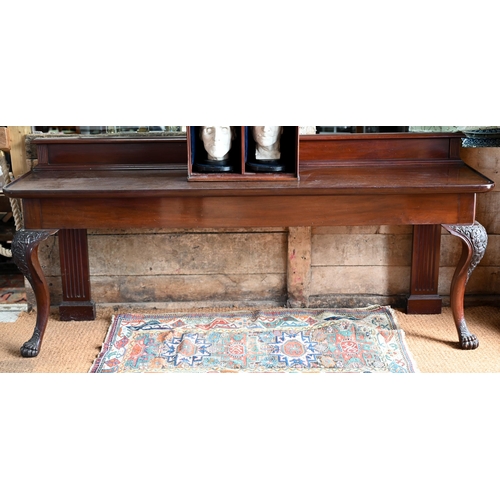 A Victorian country house mahogany console or silver table, the rectangular dished top with upstand, over a plain frieze and raised on hip carved cabriole front legs and reeded square pilaster rear legs, 213 cm w x 57 cm x 92 cm h o/all (the top cm 79 cm h)