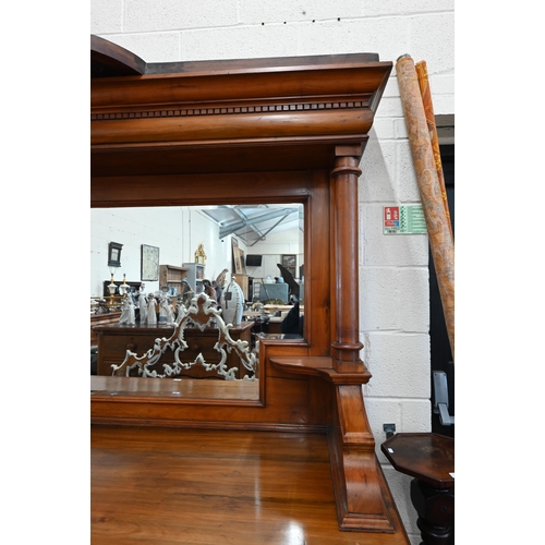 101 - A substantial Art Nouveau carved walnut mirror-backed sideboard with bevelled plate between turned p... 