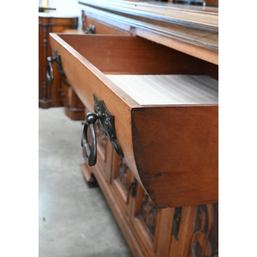 101 - A substantial Art Nouveau carved walnut mirror-backed sideboard with bevelled plate between turned p... 