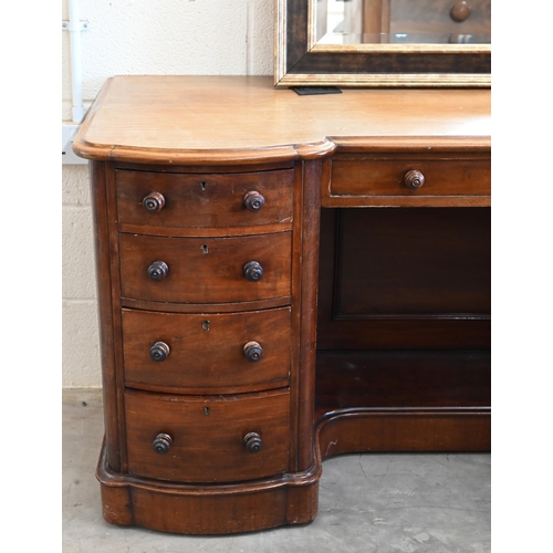 102 - A Victorian mahogany serpentine front dressing table with nine drawers to/w an oval mahogany framed ... 