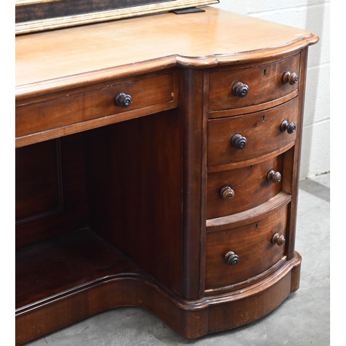 102 - A Victorian mahogany serpentine front dressing table with nine drawers to/w an oval mahogany framed ... 