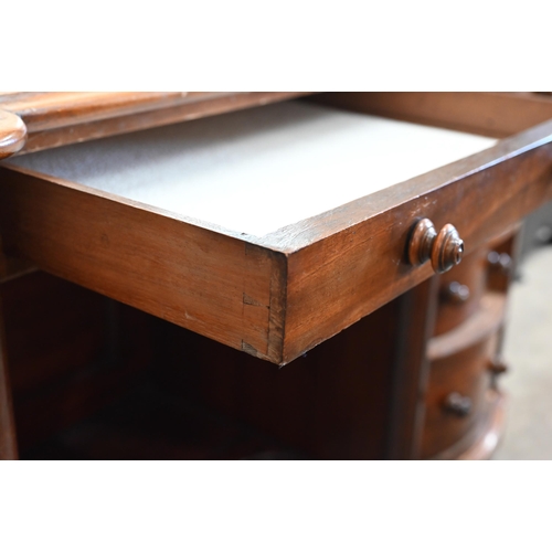 102 - A Victorian mahogany serpentine front dressing table with nine drawers to/w an oval mahogany framed ... 