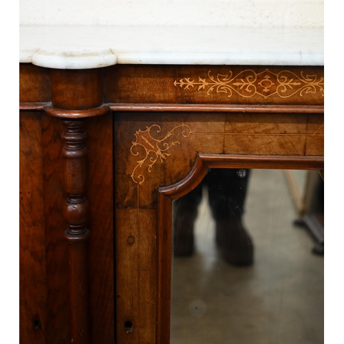 103 - A Victorian walnut inlaid credenza with marble top over a mirrored central door between panelled cup... 