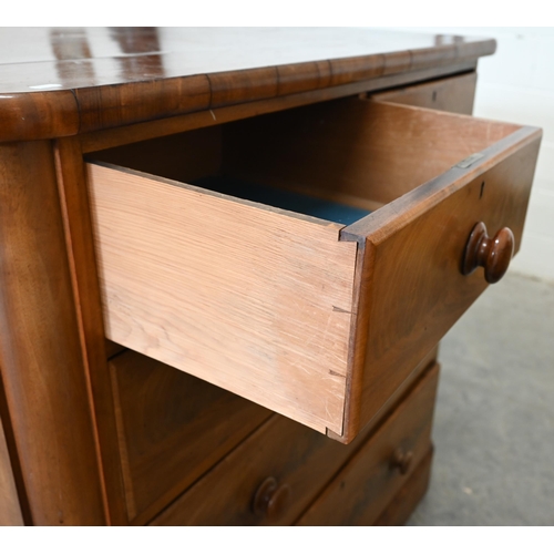 12 - A large Victorian mahogany chest of two short over three long drawers with turned handles, raised on... 