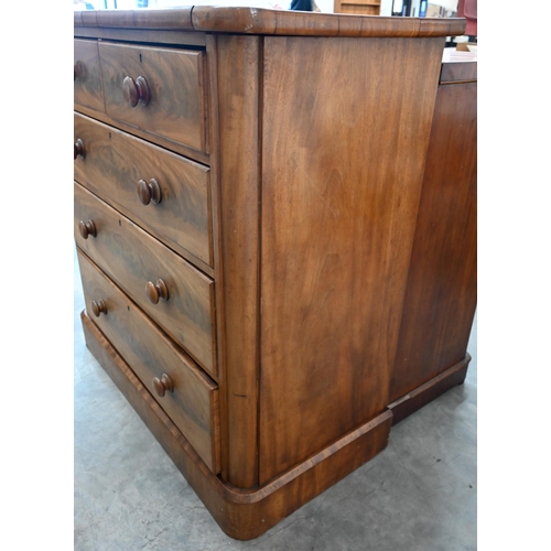 12 - A large Victorian mahogany chest of two short over three long drawers with turned handles, raised on... 