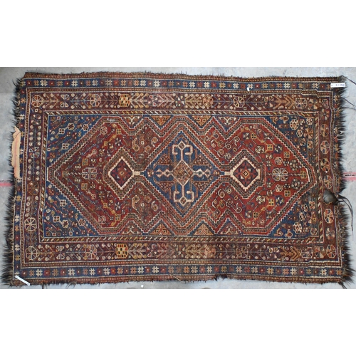 17 - An antique Persian Shiraz rug with geometric and stylised floral design, 200 cm x 126 cm to/w a Paki... 