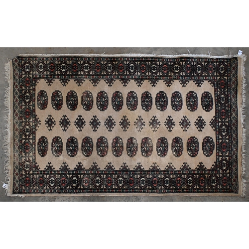 17 - An antique Persian Shiraz rug with geometric and stylised floral design, 200 cm x 126 cm to/w a Paki... 