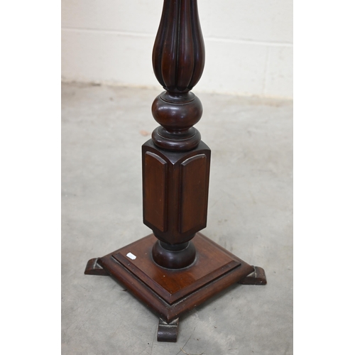 21 - A mahogany jardiniere stand with turned and reeded baluster column and square base, 103 cm high