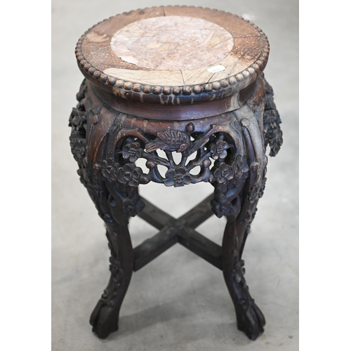 26 - A late 19th century Chinese Hongmu marble top jardiniere stand, carved and pierced with birds and pr... 