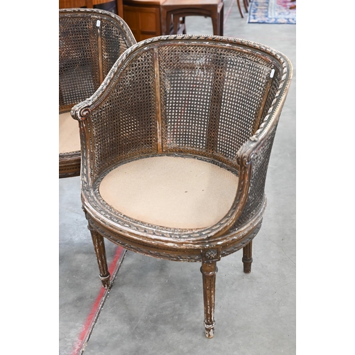 31 - A pair of antique French giltwood framed double-caned bergere chairs in the Louis XVI style (a/f)