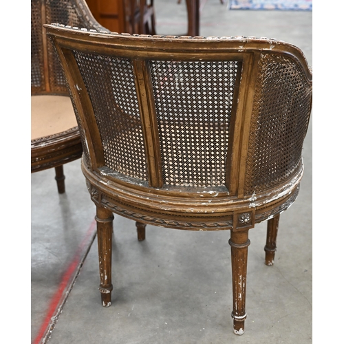 31 - A pair of antique French giltwood framed double-caned bergere chairs in the Louis XVI style (a/f)