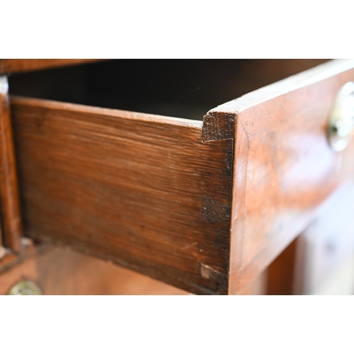 36 - A Georgian walnut feather banded chest of two short over three long graduating drawers raised on sha... 