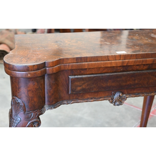 4 - A George II style figured walnut gate-leg card table, the shaped baize lined folding top over a sing... 