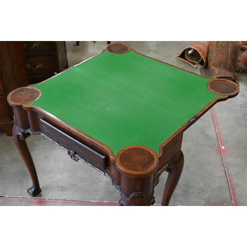 4 - A George II style figured walnut gate-leg card table, the shaped baize lined folding top over a sing... 