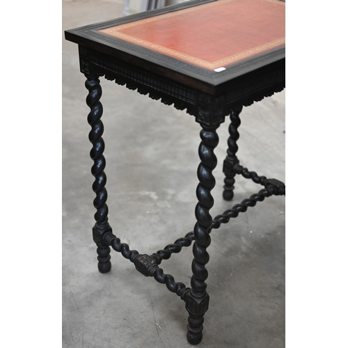 41 - A late 19th century ebonised writing table (restored) the ripple carved top inset with gilt tooled t... 