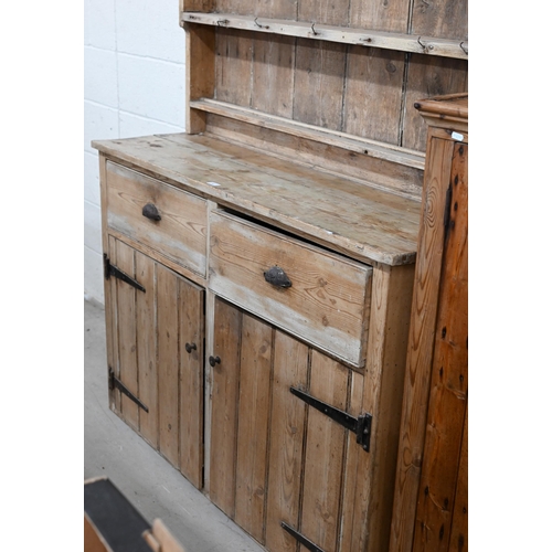 42 - An antique pine provincial dresser with graduated plate rack over two drawers and cupboards, 36 cm w... 