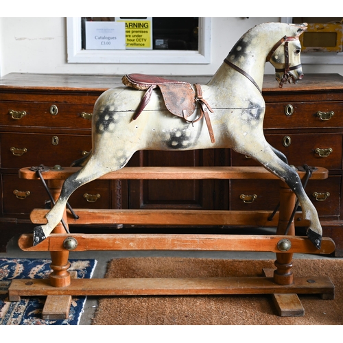 A 1920s wooden dapple-gray rocking horse, probably a Lines Brothers 'Sportiboy', on trestle base, 110 x 135 cm, for restoration