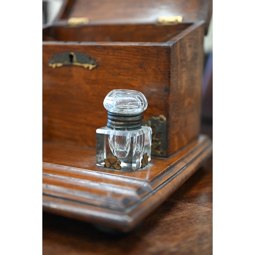 464 - An antique oak stationery box/inkstand with brass mounts, 28 cm wide