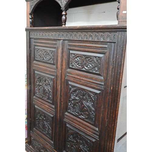 48 - A 17th century oak court cupboard, the recessed canted sided upper cupboard with arcaded moulded pan... 