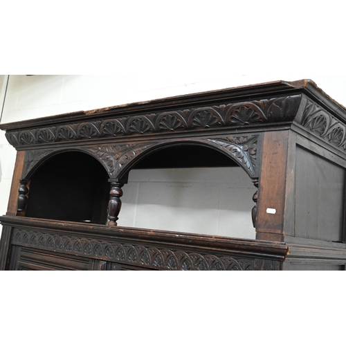 48 - A 17th century oak court cupboard, the recessed canted sided upper cupboard with arcaded moulded pan... 