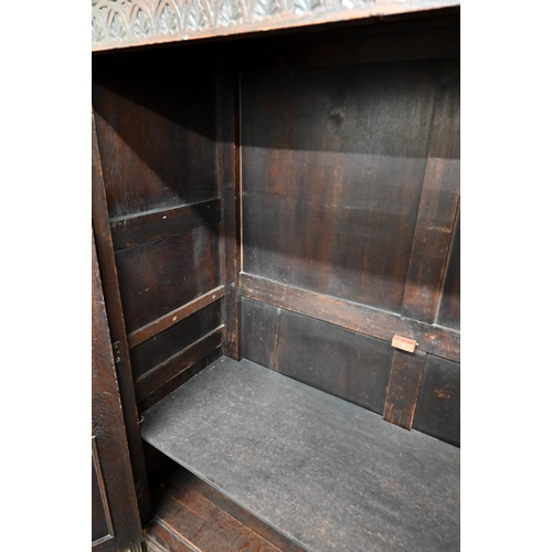 48 - A 17th century oak court cupboard, the recessed canted sided upper cupboard with arcaded moulded pan... 