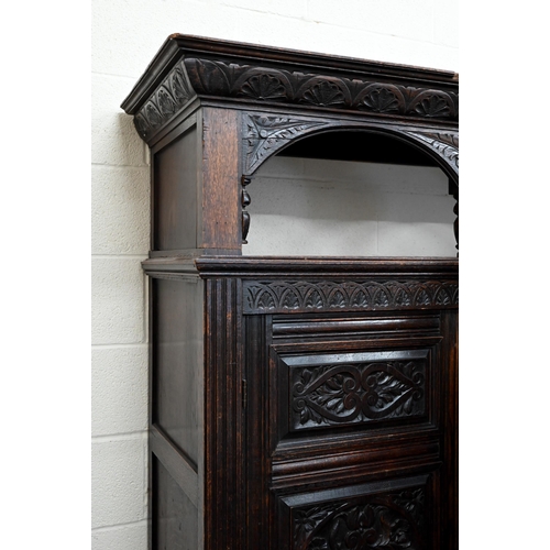 48 - A 17th century oak court cupboard, the recessed canted sided upper cupboard with arcaded moulded pan... 