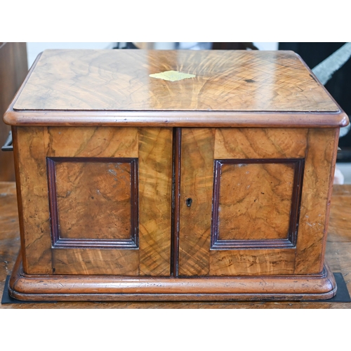 488 - A Victorian walnut canteen with flush brass side handles, twin panel doors enclosing four drawers, c... 