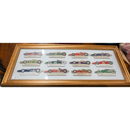 496 - Two modern tinplate bi-planes, a framed set of 1960s printed card Formula 1 racing cars and a 'The S... 