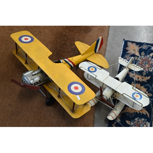 496 - Two modern tinplate bi-planes, a framed set of 1960s printed card Formula 1 racing cars and a 'The S... 