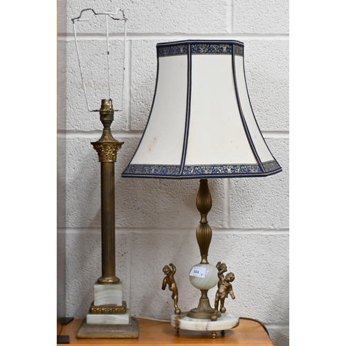 504 - Two brass and onyx table lamps to/w an Art Deco style plaster wall mask and a cow bell (4)