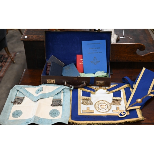 505 - Two Masonic aprons and sash with regalia, to/w various books etc in leather 'Pakawa' case