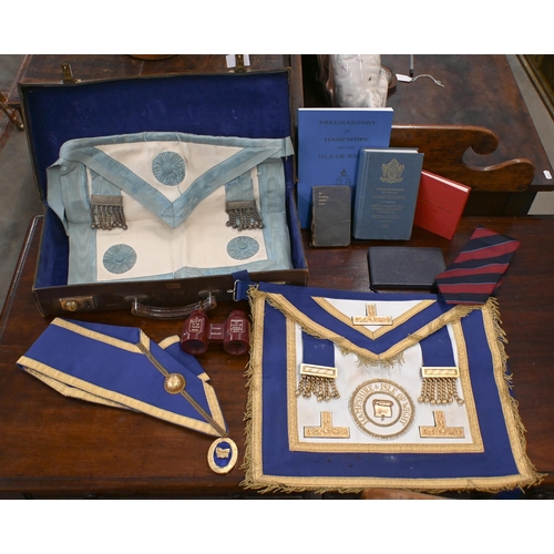 505 - Two Masonic aprons and sash with regalia, to/w various books etc in leather 'Pakawa' case