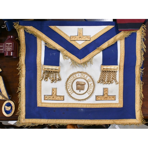 505 - Two Masonic aprons and sash with regalia, to/w various books etc in leather 'Pakawa' case