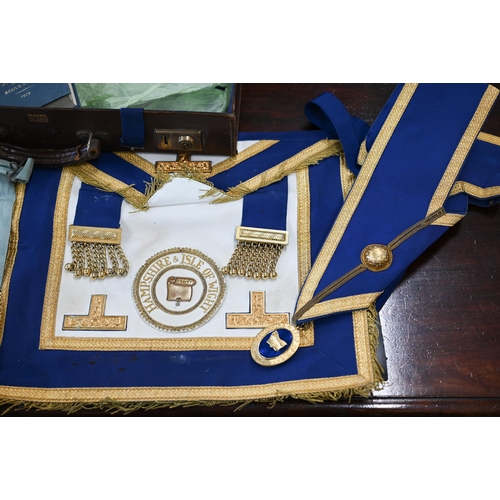 505 - Two Masonic aprons and sash with regalia, to/w various books etc in leather 'Pakawa' case