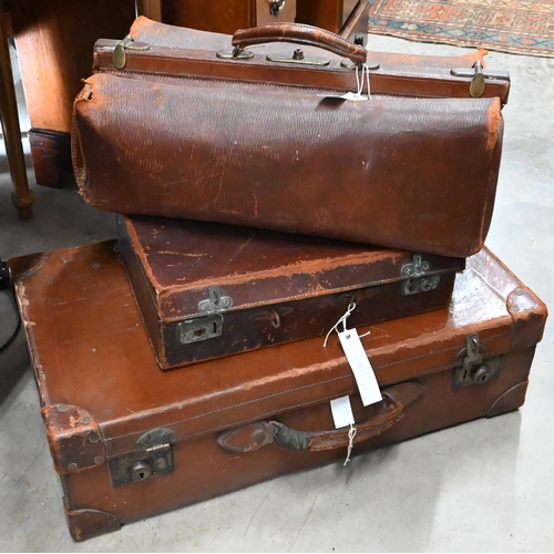 512 - # An antique leather Gladstone bag and two vintage leather suitcases (3 - a/f)