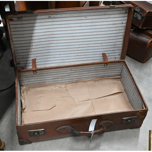 512 - # An antique leather Gladstone bag and two vintage leather suitcases (3 - a/f)