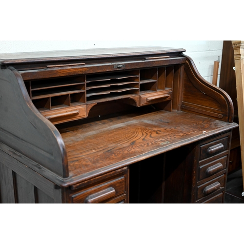 54 - An early 20th century oak tambour roll-top desk with eight drawers, 128 cm w x 78 cm d x 120 cm h