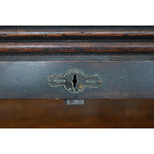 54 - An early 20th century oak tambour roll-top desk with eight drawers, 128 cm w x 78 cm d x 120 cm h