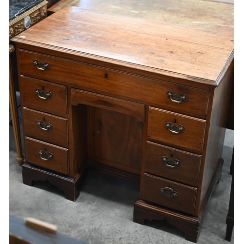 59 - A 19th century mahogany kneehole desk with arrangements of eight drawers around the recessed central... 