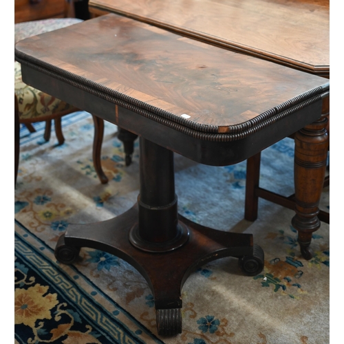 62 - A Regency mahogany and rosewood cross banded folding card table with turned column and quadraform ba... 