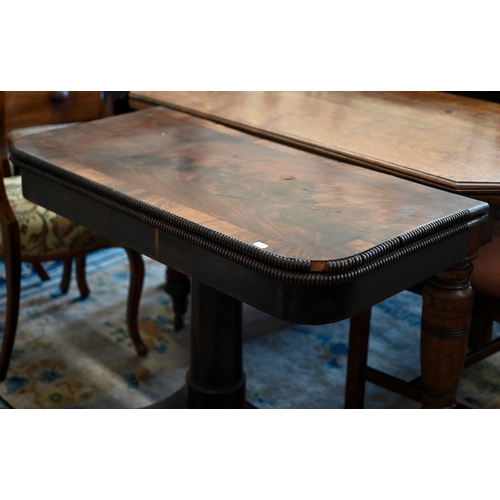 62 - A Regency mahogany and rosewood cross banded folding card table with turned column and quadraform ba... 