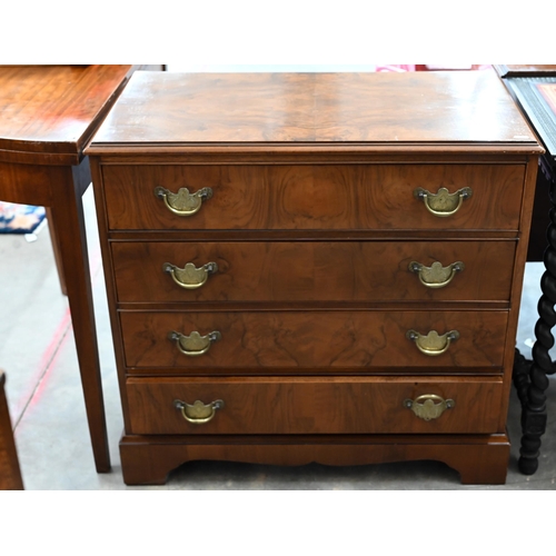 63 - A George III style walnut chest with four long drawers fitted with brass handles, raised on bracket ... 