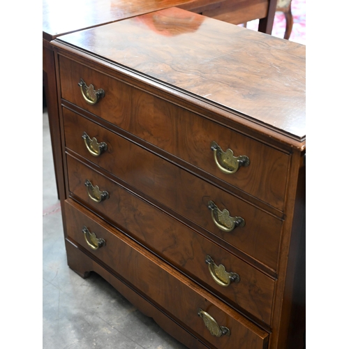 63 - A George III style walnut chest with four long drawers fitted with brass handles, raised on bracket ... 